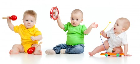 Babies Play Musical Toys. Isolated On White Background